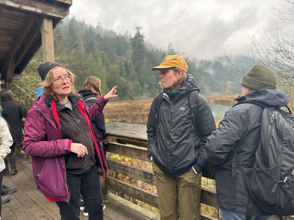 An instructor speaks with students near the Goldstream Estuary