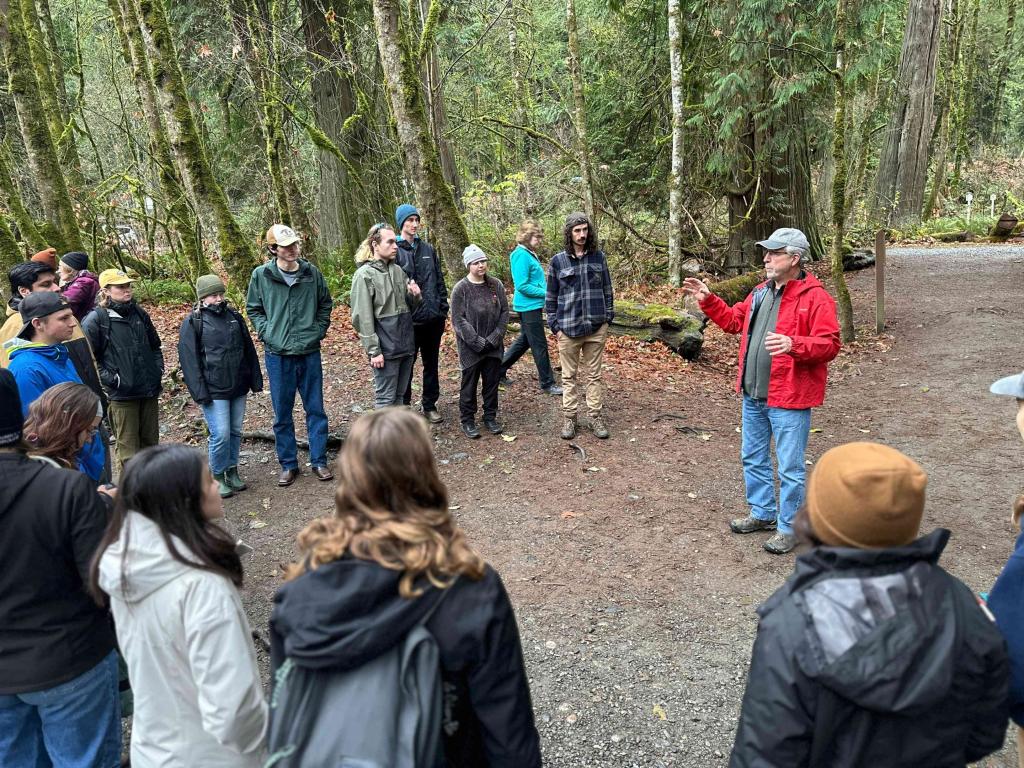 Students hear from a fish hatchery volunteer at Goldstream Park.