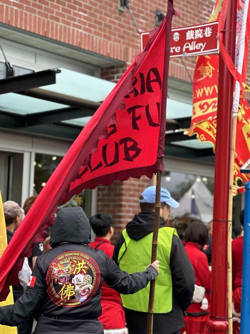 People seen holding red flags in Victoria's Chinatown