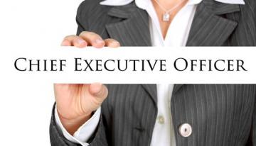 Person in a business suit holding a sign saying Chief Executive Officer.