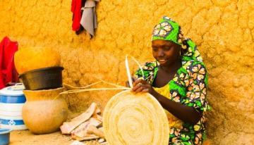 Picture of woman weaving a basket