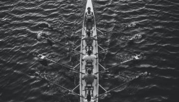 A boat with rowers in it.
