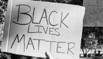 Cardboard sign with words Black Lives Matter