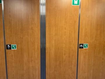 Doors with confusing instructional signage.