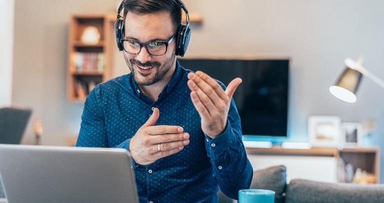 Person-speaking into their laptop and using hand gestures