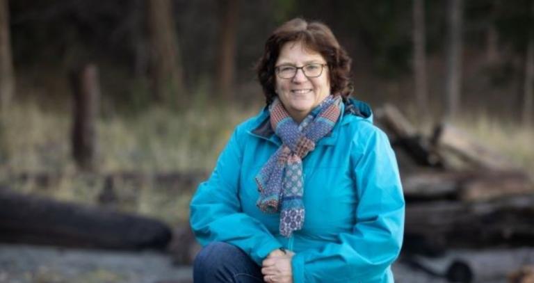 Jacquie Gilson sitting outside.