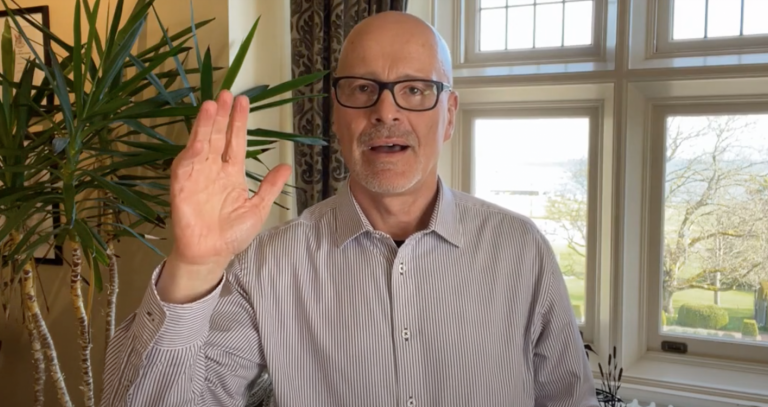 President Philip Steenkamp in office in front of bright window.