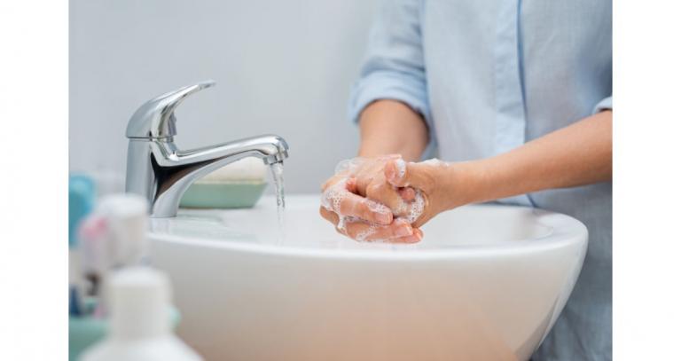 Person washing hands at a sink