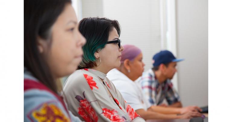 Four people look to the right, listening and concentrating