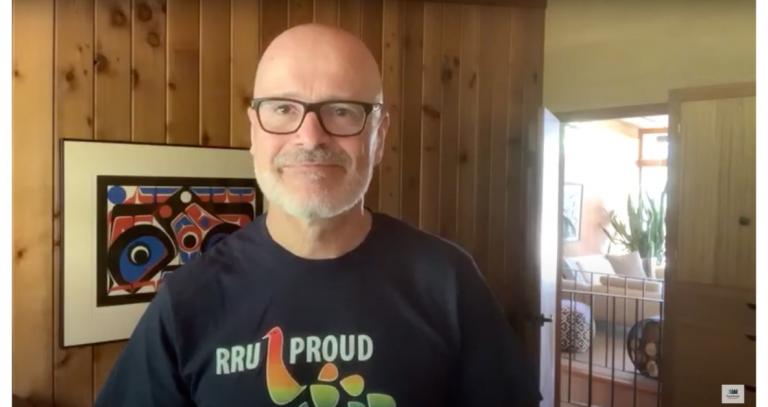 Still from video of President Philip Steenkamp indoors wearing RRU Proud t-shirt