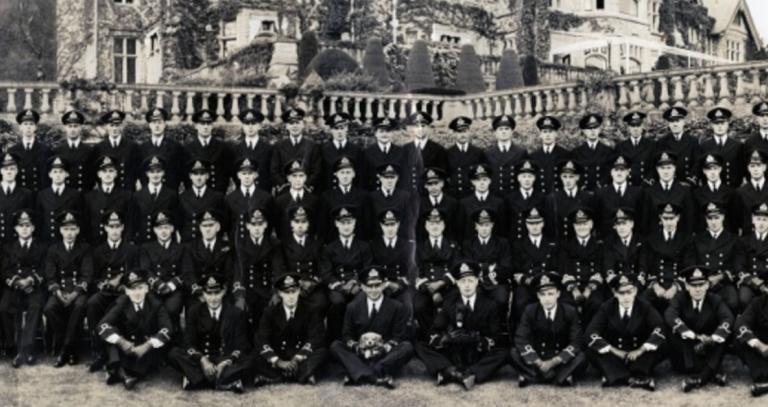 Class photo of military college graduates at RRU in black and white