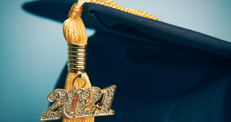 A grad cap with a gold tassel and 2021.