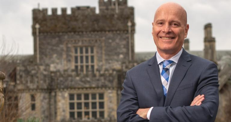 President Steenkamp smiling in front of Hatley Castle