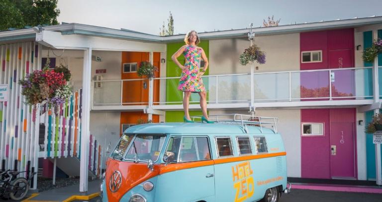 Hotel Zed CEO Mandy Farmer stands on the hotel's vintage VW bus. Photo by Women of Influence. P