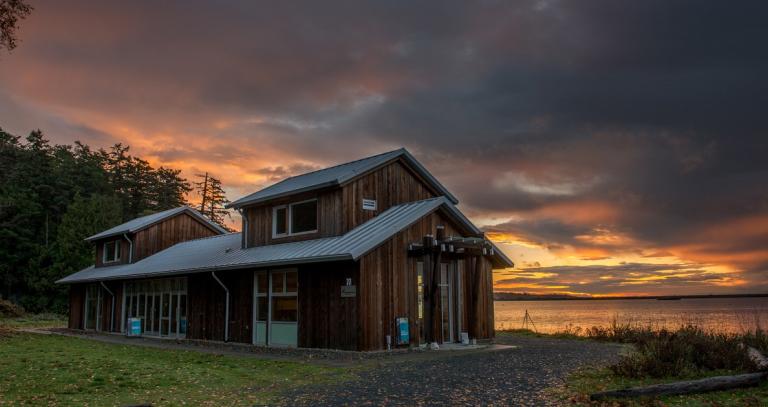 Sneq’wae’lun (Blue Heron House) on the shores of the Esquimalt Lagoon at sunrise..