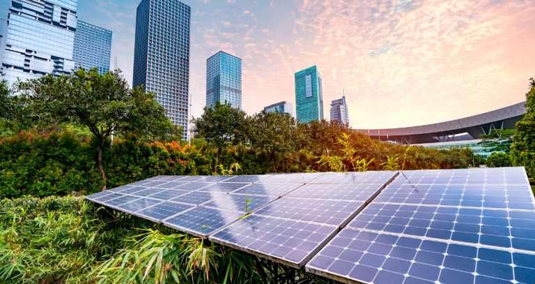 Solar panels can be seen in the foreground of a city scape.
