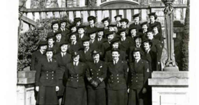 Royal Roads' "Wrens" standing in rows up a staircase 5 rows deep in uniform. Eileen Maurice is bottom row, second to the right