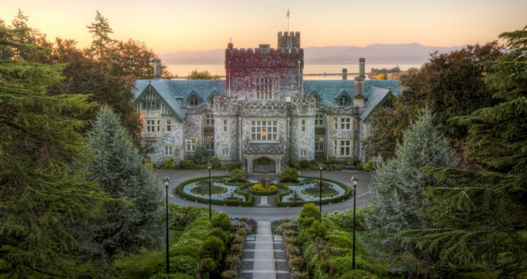 Hatley Castle is pictured from the front, a glowing sky can be seen in the distance.