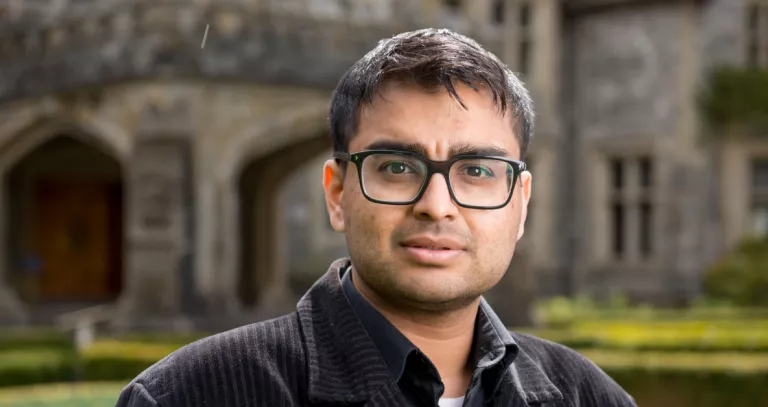 Head shot of Ash Prasad standing in front of Hatley Castle