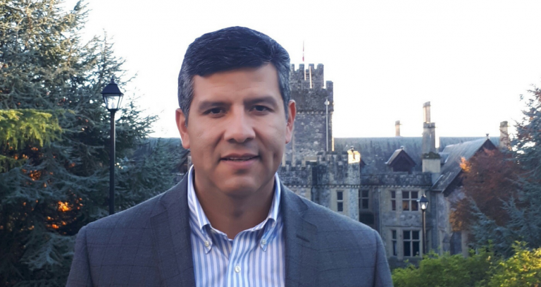 Head shot of Juan Navarro with Hatley Castle in the background