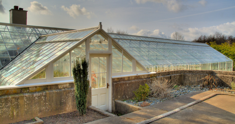 A glass house can be seen on a sunny day.