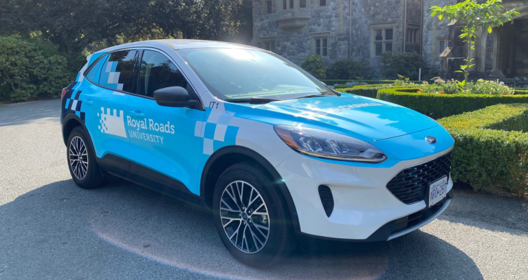 RRU branded electric vehicle in front of castle.