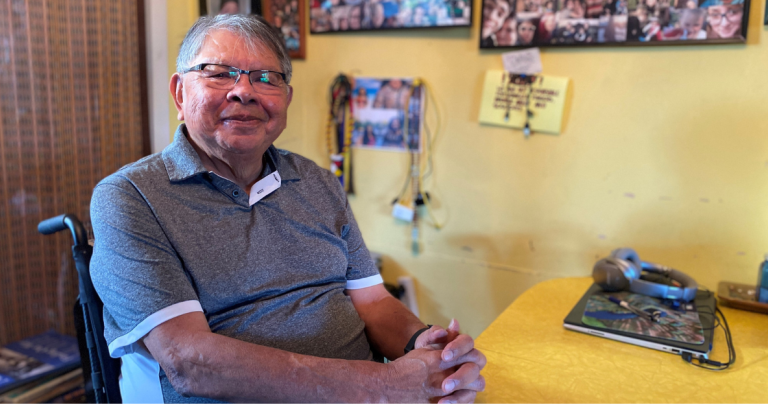 Dr. Butch Dick sits at his kitchen table in his home.