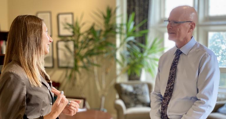 Dr. Wanda Krause speaking with President Philip Steenkamp in his office.