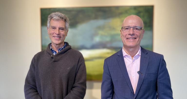 Royal Roads University President Philip Steenkamp standing in his office with Dr. Thomas Homer-Dixon.