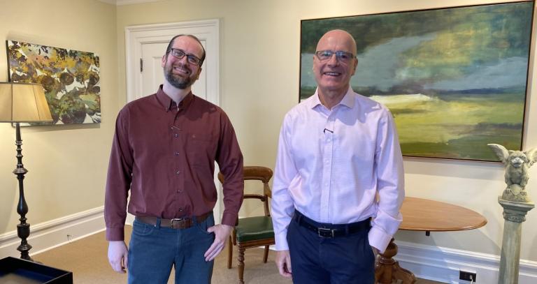 Dr. Robert Newell and President Philip Steenkamp chat in Steenkamp's office.