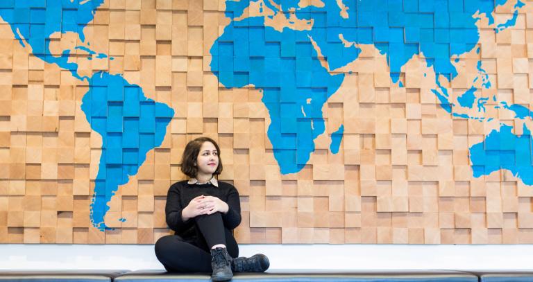 student sitting infront of map