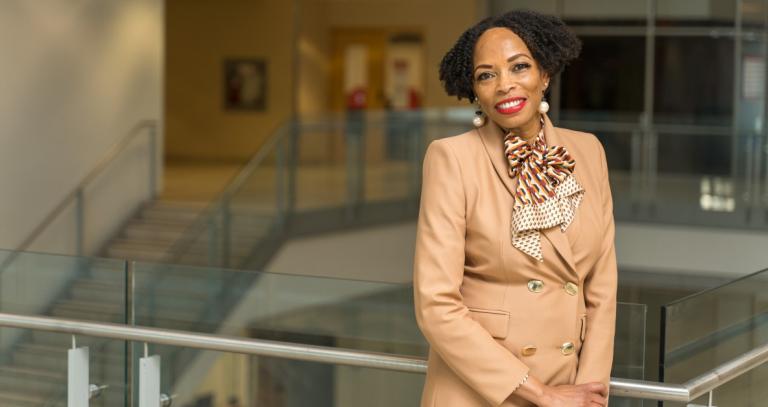 Andrea Davis standing in a modern building.