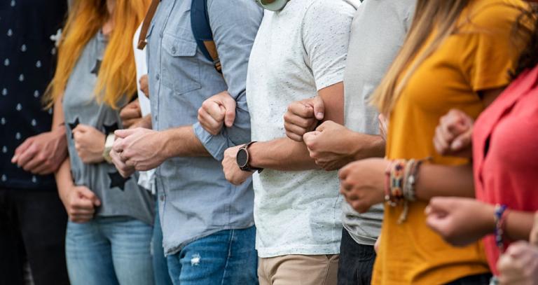 People link arms in a line, standing in solidarity for climate action.