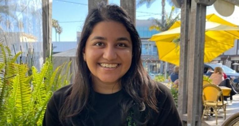 Jessica Rita Rampersad smiling at camera wearing a black shirt.