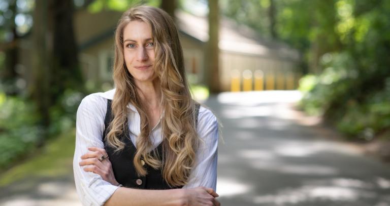 Rebecca Pearce smiling with the Cascade Institute building behind her.