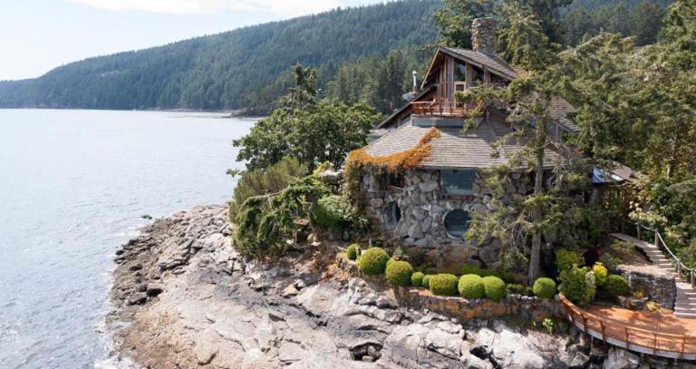 An aerial view of the Bloom Castle by the sea along the coastline of Salt Spring Island.