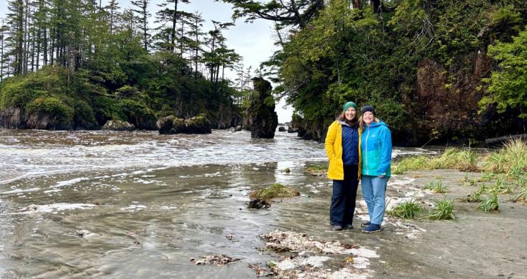 Professors Rebecca Wilson-Mah and Ann-Kathrin McLean stand on a beach.