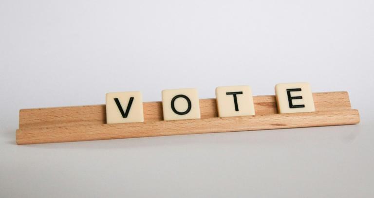 Scrabble tiles spelling vote