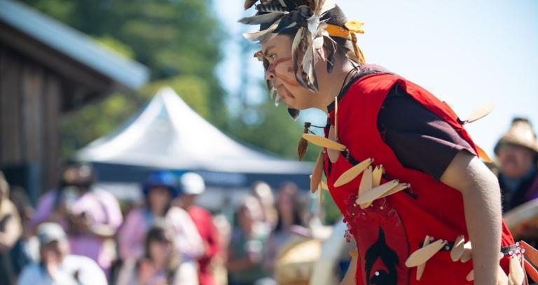 A young boy, dressed in regalia, dances during NIPD celebrations