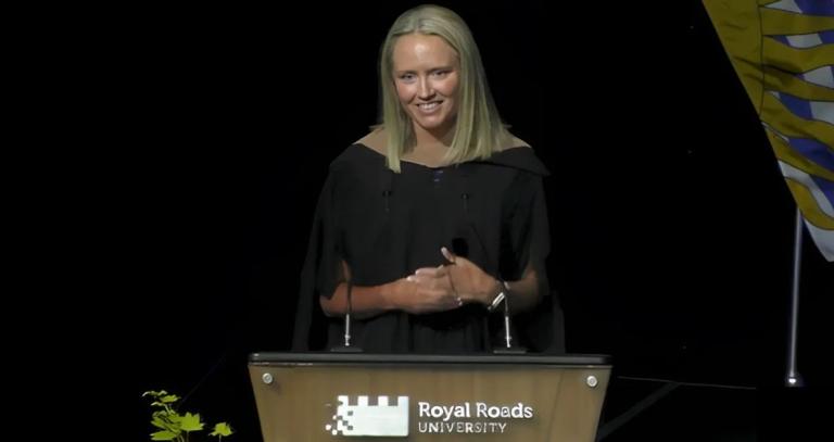 A woman stands a podium