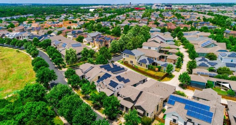 A community of houses with solar panels on the rooves.