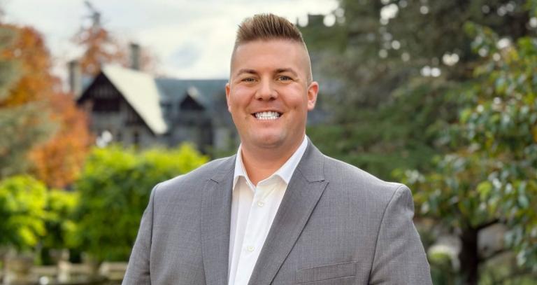 Jonathan Hesler smiling with Hatley Castle in the background