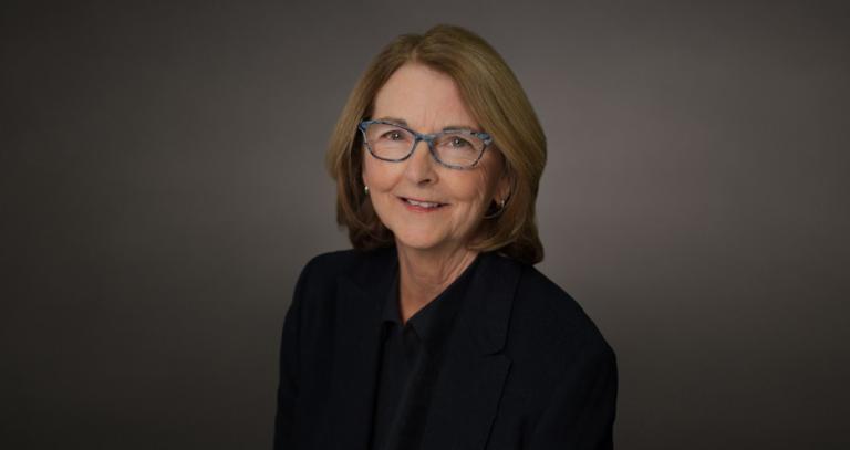 Deb Linehan smiling in front of a neutral background