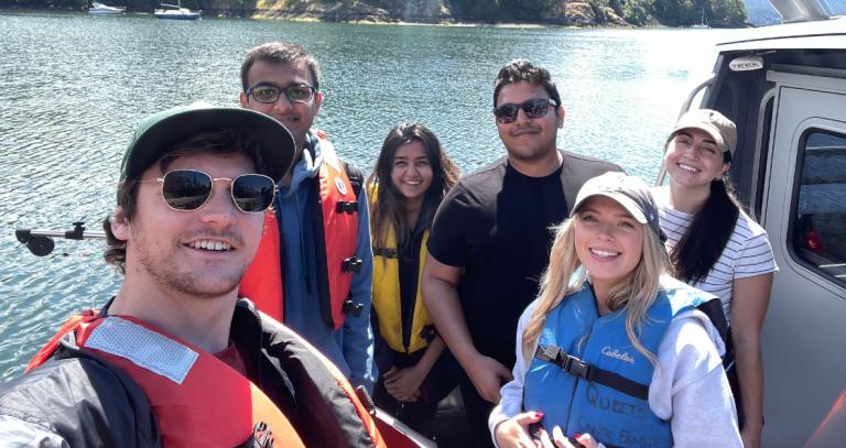 Drew Wolfe and fellow BBA classmates pose for a selfie on a boat.