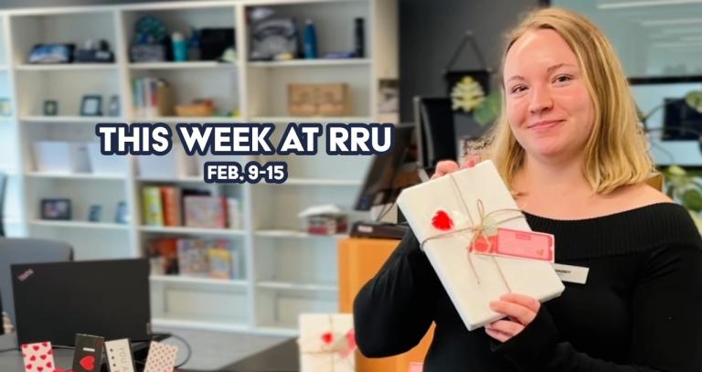 Person holding a book at RRU.