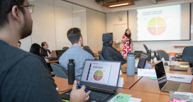A full classroom of Justice Studies students attending a lecture on the foundations of justice studies. 