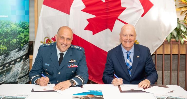 Major-General Jeannot Boucher, Commander of the Canadian Defence Academy, and Dr. Philip Steenkamp, President and Vice-Chancellor of Royal Roads University, sign an agreement during a ceremony in Kingston, Ontario, on April 24, 2026. Photo by: Corporal Brandon Liddy