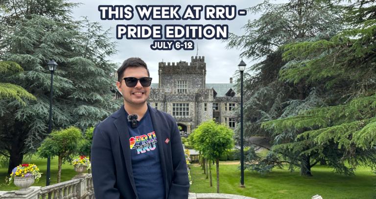 Man standing in front of Hatley Castle with a navy shirt saying 'RRU Pride'
