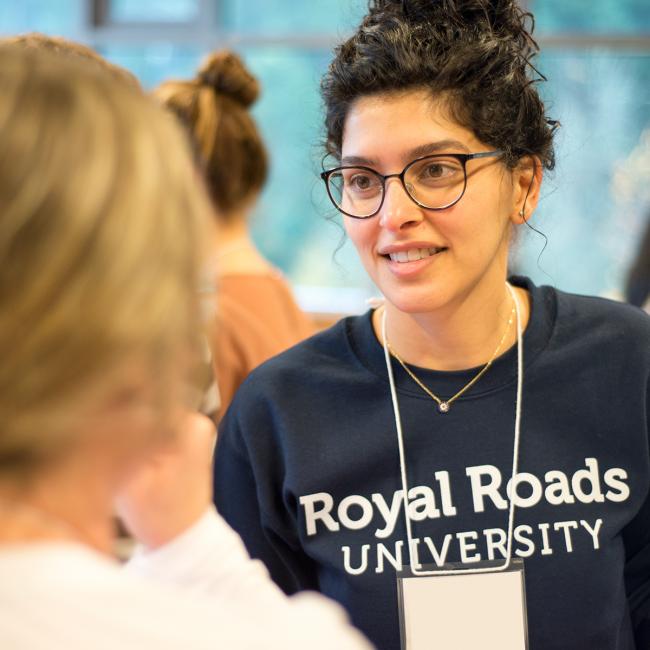 Student-with-Royal-Roads-University-sweatshirt-and-lanyard
