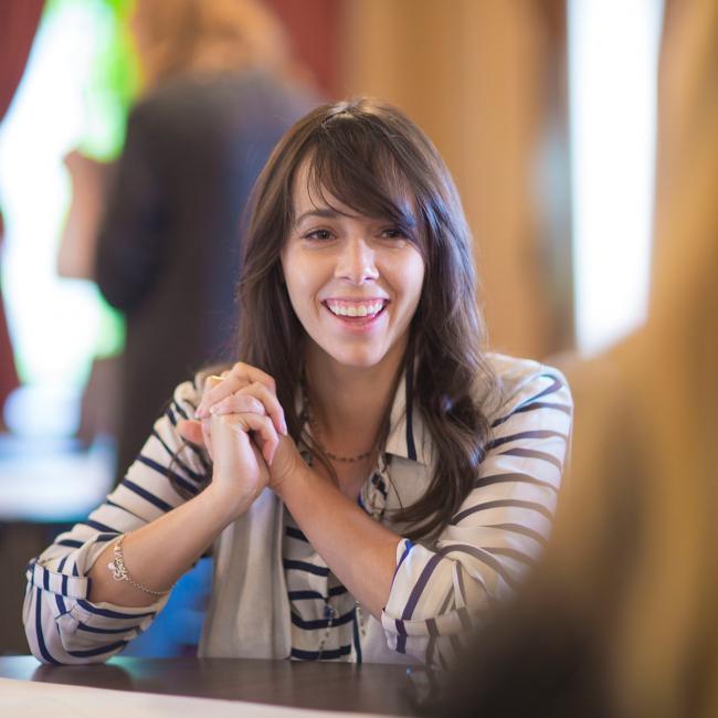 Student-clasping-hands-and-smiling